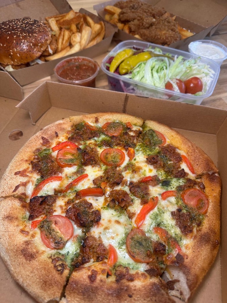 Caspian Kebab’s Kiev Bolognese pizza, peri peri chicken burger, and hot honey chicken tenders served with fries.