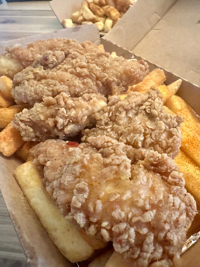 Sweet and spicy hot honey chicken tenders served with red salted fries from Caspian Kebab.