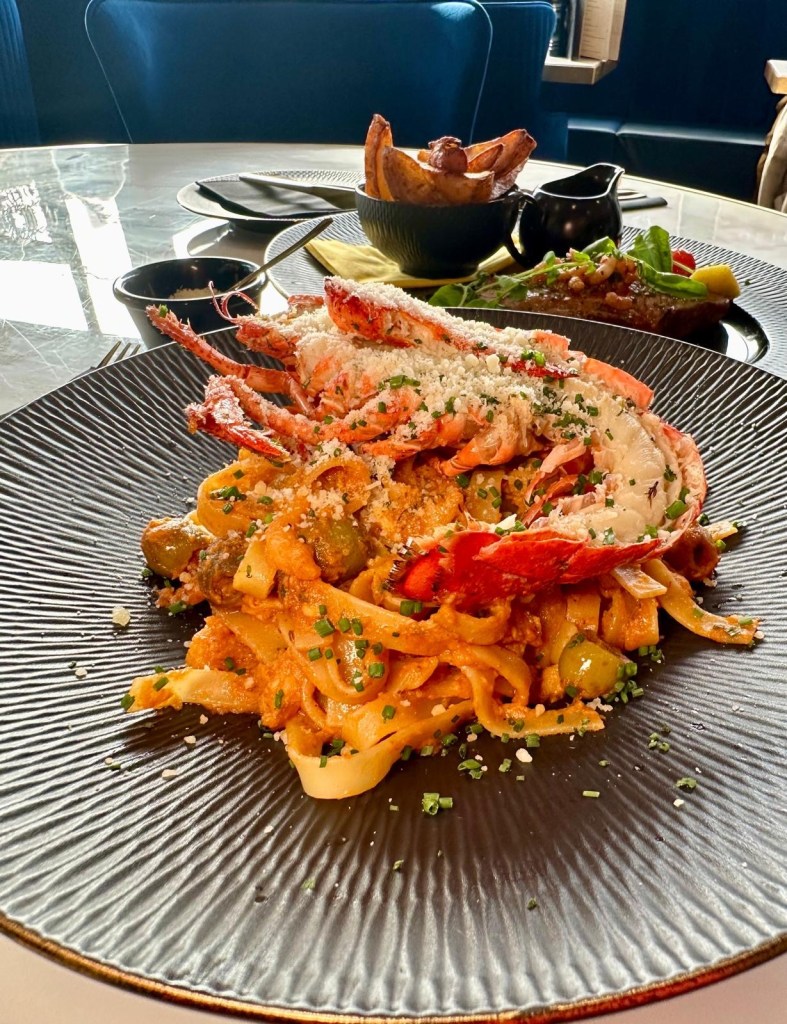 Lobster pasta at Wyvestow’s South Shields with prawns, anchovies, olives, and Bloody Mary sauce, topped with half a lobster