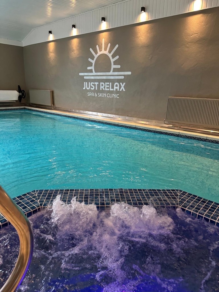 Heated indoor pool and spa area at High Hill Stay with sauna, steam room, and relax lounge.