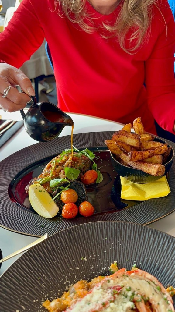Seafood and chorizo butter sauce being poured over a 10oz sirloin steak at Wyvestow’s South Shields