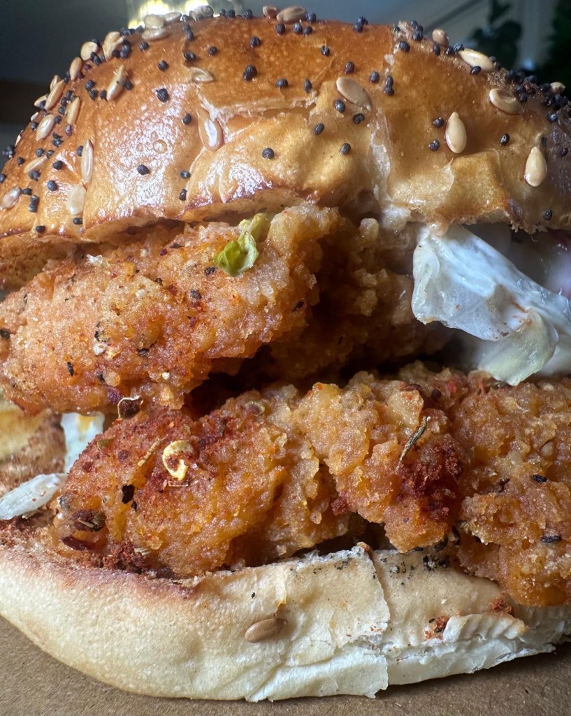 Crispy peri peri chicken burger stacked high with Cajun fries at Caspian Kebab Birtley.