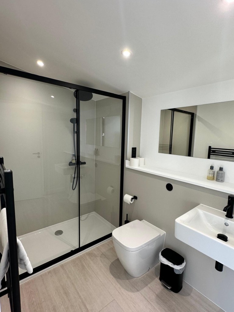Stylish bathroom with modern fixtures and elegant design in The Valley Lodge at High Hill Stay.