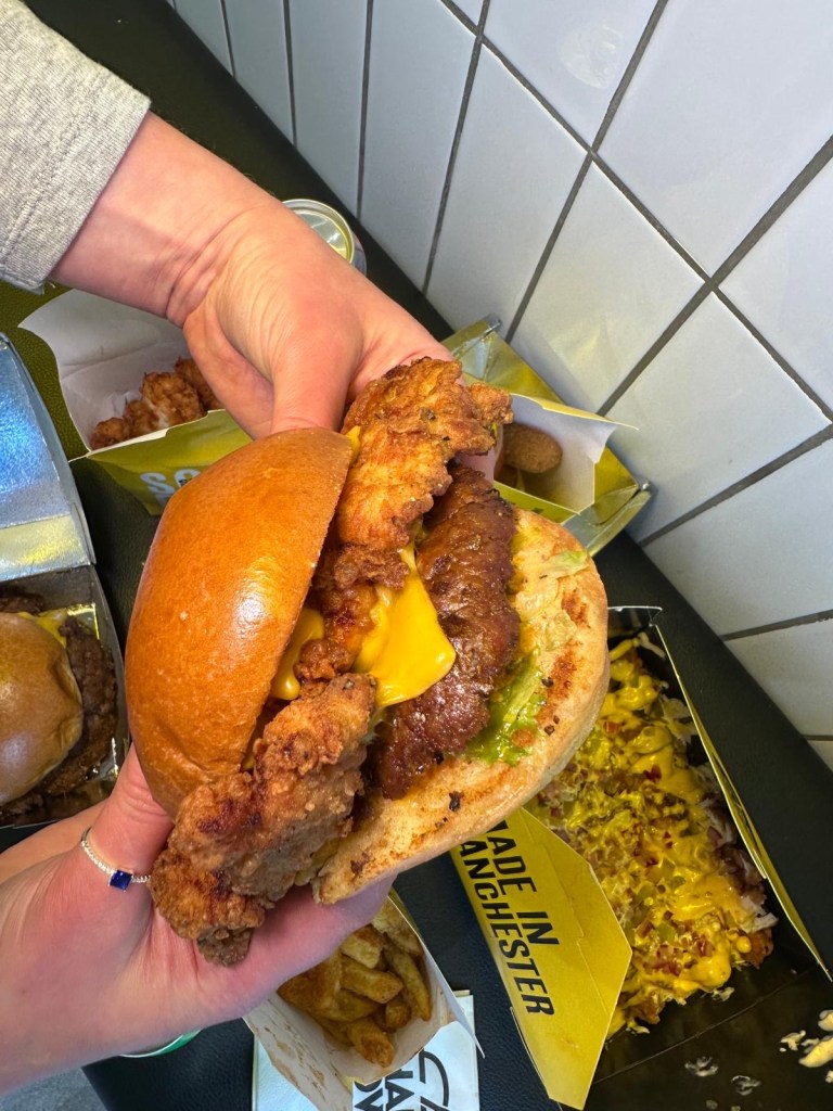 Hearty Stack Sandwich with chicken and beef patties, cheese, and sauce at Shakedown Newcastle.