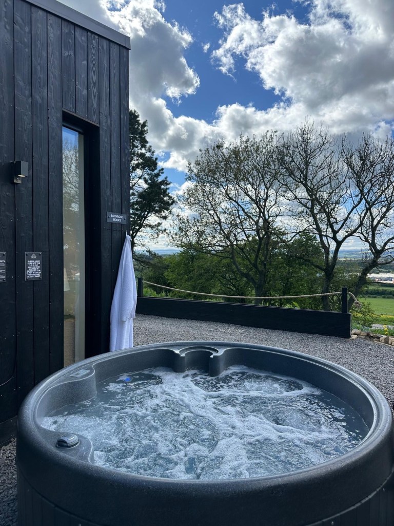 Private outdoor hot tub overlooking Durham countryside at High Hill Stay lodge.
