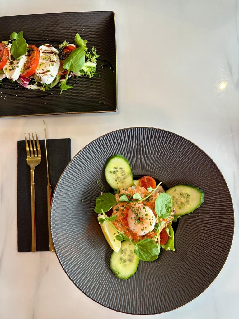 Selection of elegant starters at Wyvestow’s South Shields including prawn cocktail with king prawn garnish and Caprese salad with buffalo mozzarella and fresh basil