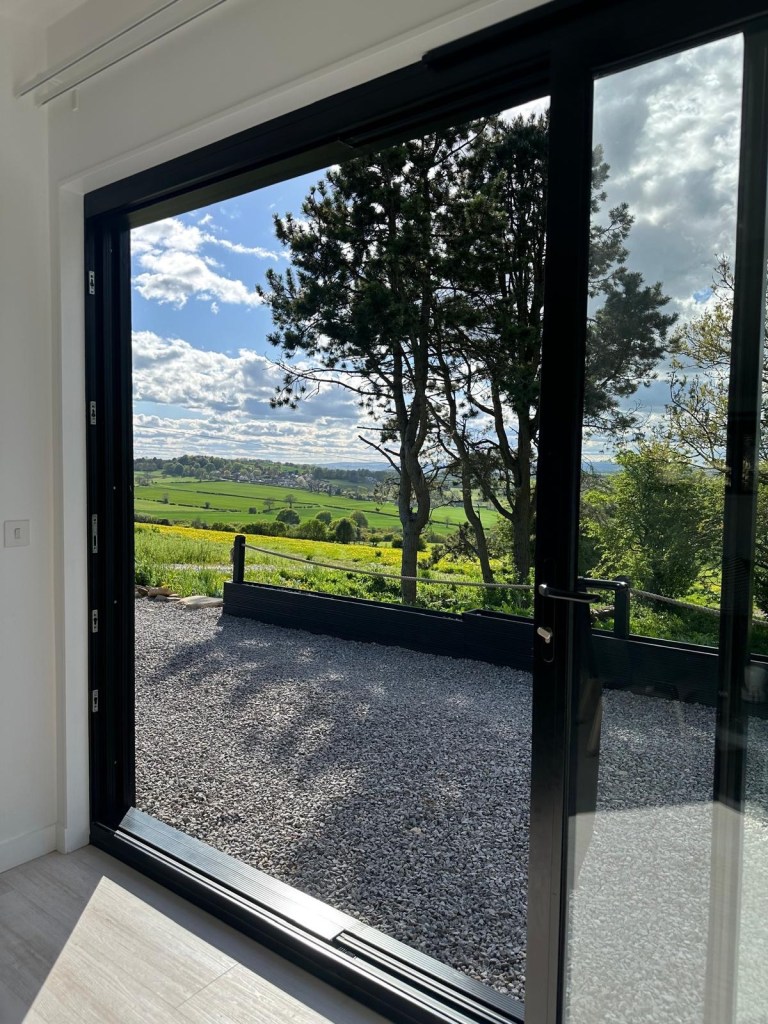 Peaceful countryside view of trees and open sky from the private lodge at High Hill Stay.