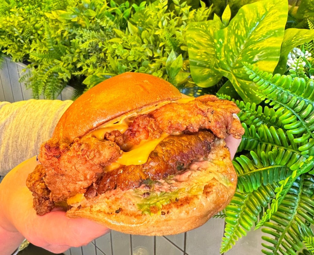 Hearty Stack Sandwich with chicken and beef patties, cheese, and sauce at Shakedown Newcastle