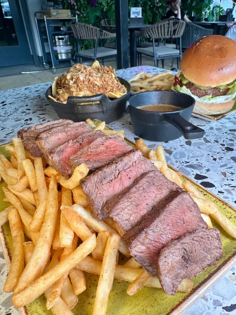 Flat iron steak with crispy seasoned fries and peppercorn sauce at River Bar Washington