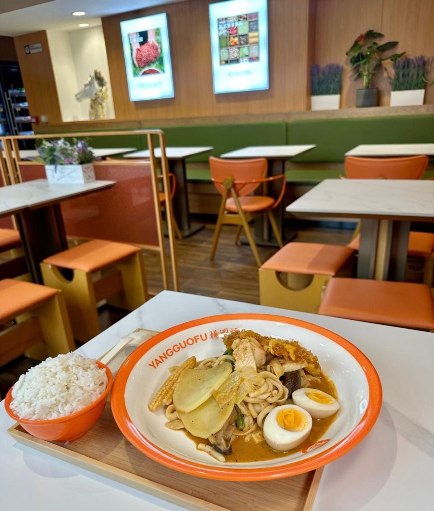 Freshly cooked Malatang bowl with king prawns, homemade noodles, and vegetables in sweet and sour broth