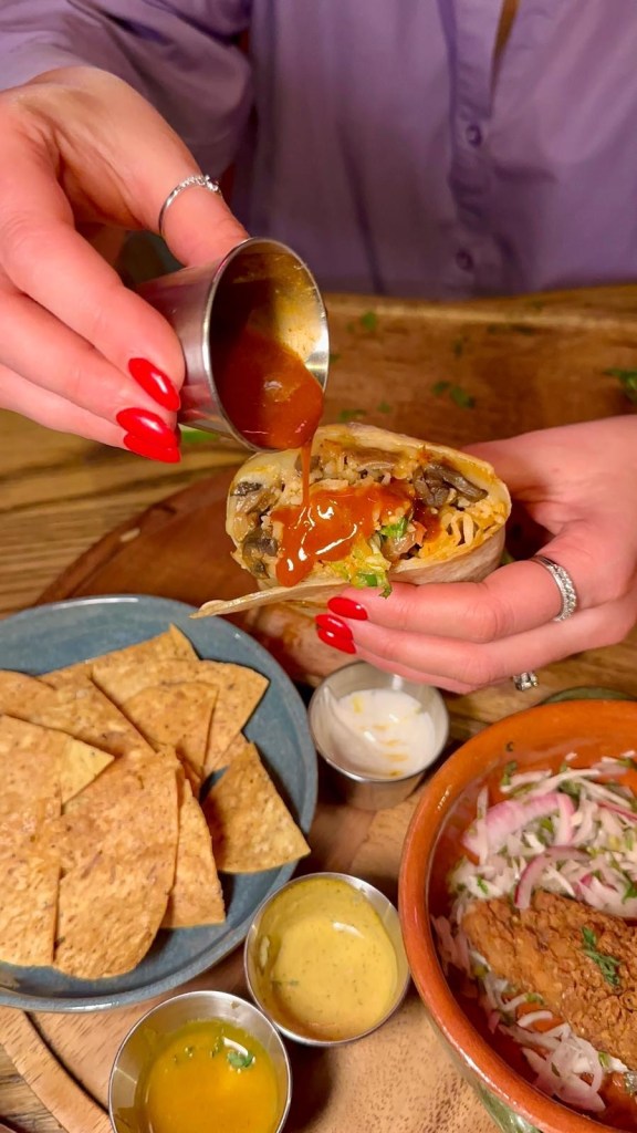 Barbacoa beef burrito with tomato rice, refried beans, pico de gallo, lettuce, and avocado salsa at Motel Mexicana Newcastle