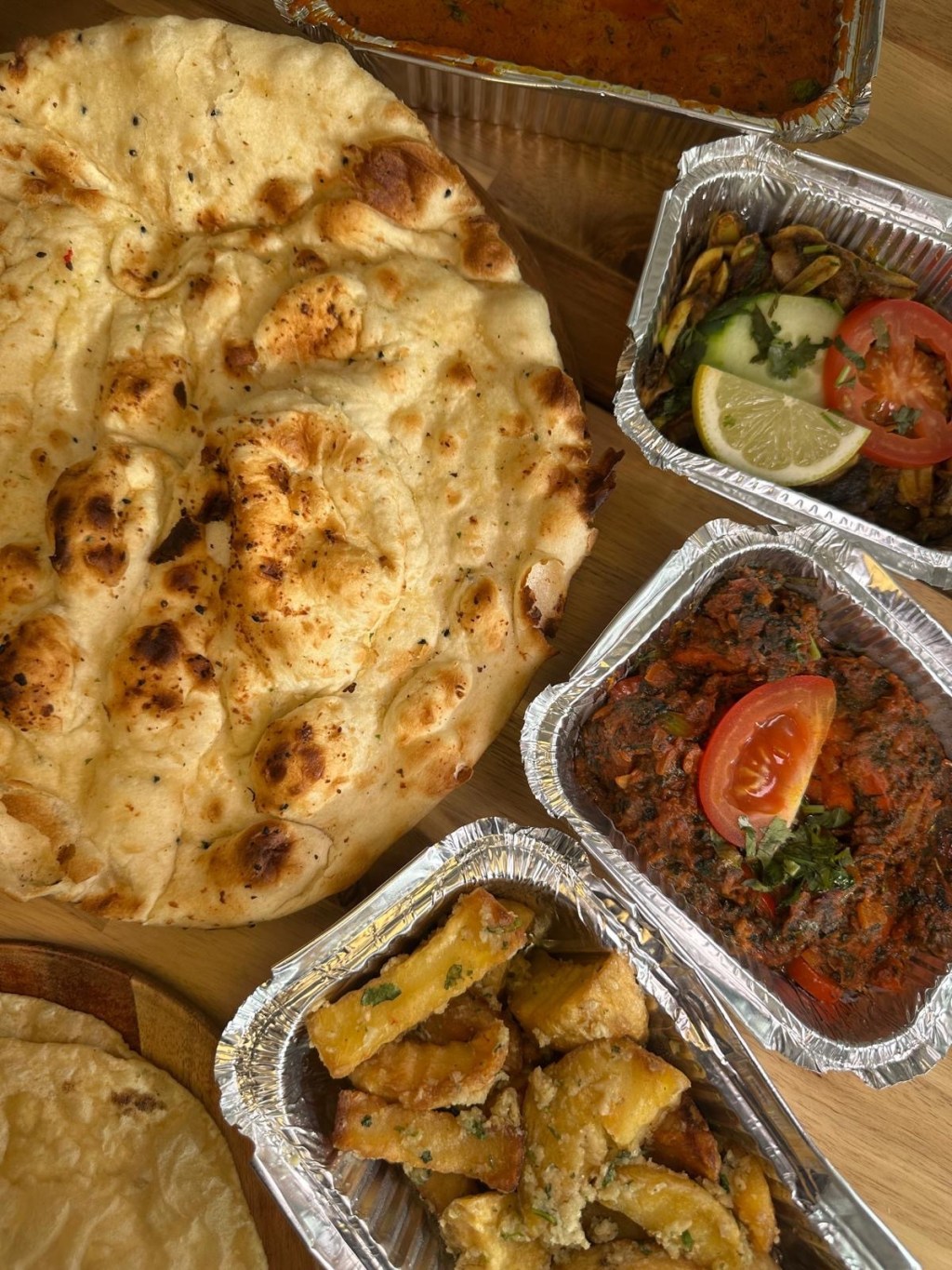 Fluffy garlic and cheese naan breads from Nisha’s Tandoori