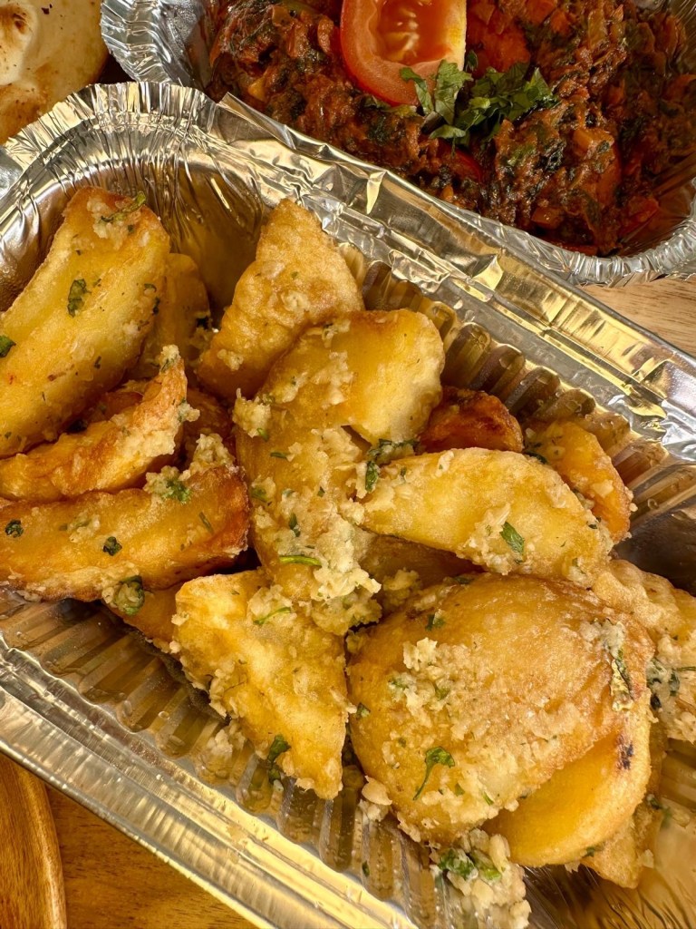 Crispy garlic chips served as a side dish from Nisha’s Tandoori