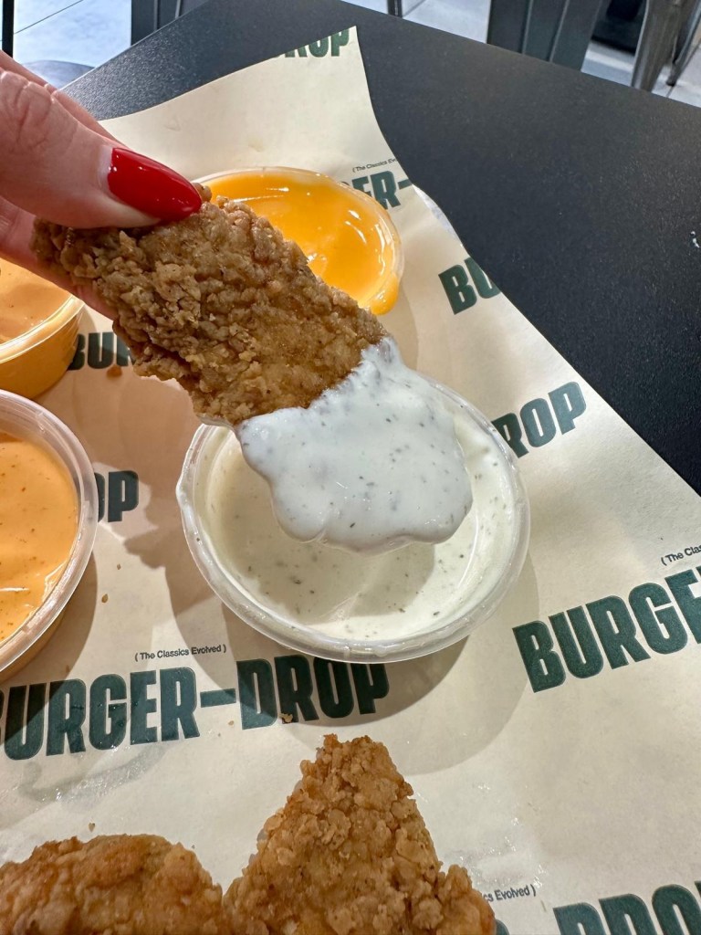Crispy chicken tender dipped in garlic sauce at Burger Drop Sunderland