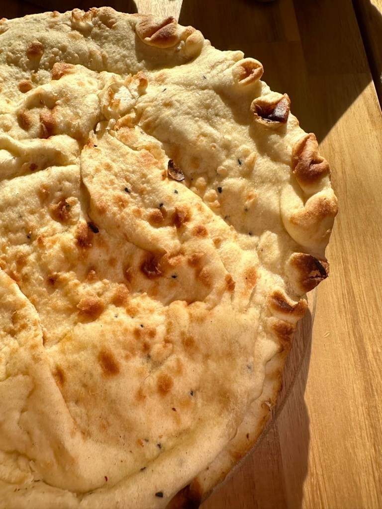 Fluffy garlic and cheese naan breads from Nisha’s Tandoori