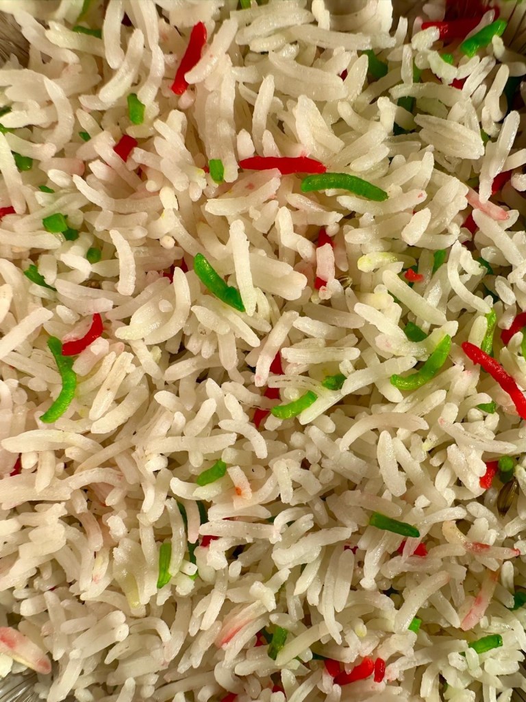 Fragrant pilau rice with mixed green and red grains from Nisha’s Tandoori