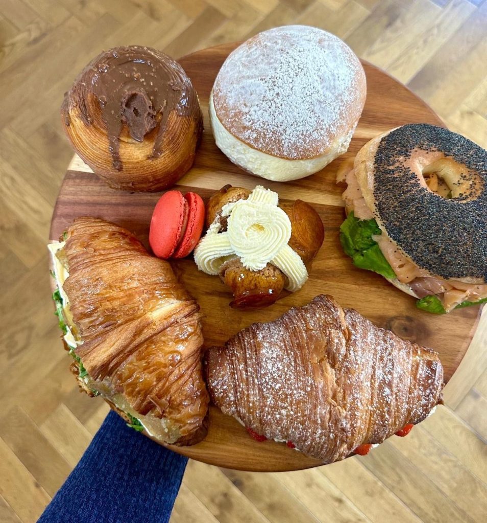 Assortment of freshly baked breads on a wooden display board at home