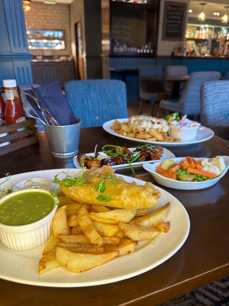 Pub food spread at The Gate in Framwellgate Moor including fish and chips, parmo, pork belly, and desserts