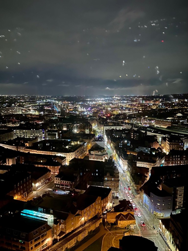 Nighttime cityscape of Newcastle from 3Sixty’s 26th floor