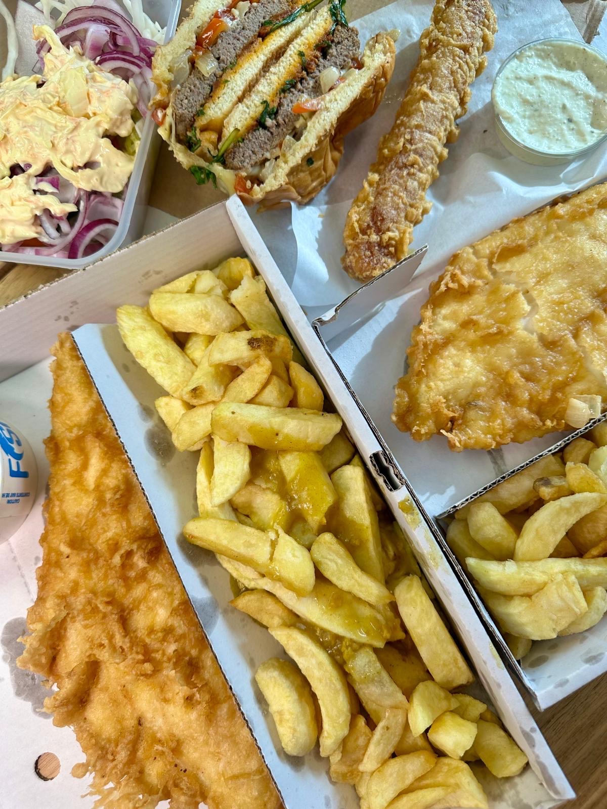 Cod and chips, burger, sausage, salad, curry sauce and tartar sauce from Krispies Fish & Chips