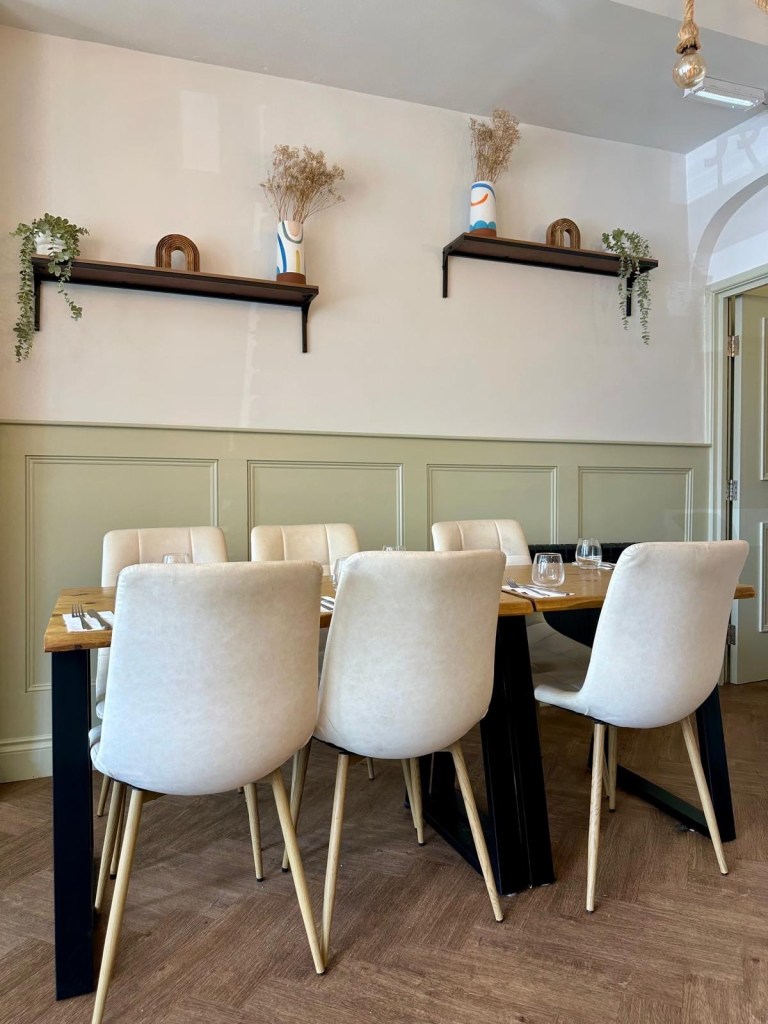 Stylish and minimal interior of Isla restaurant in Durham with warm lighting and modern decor.