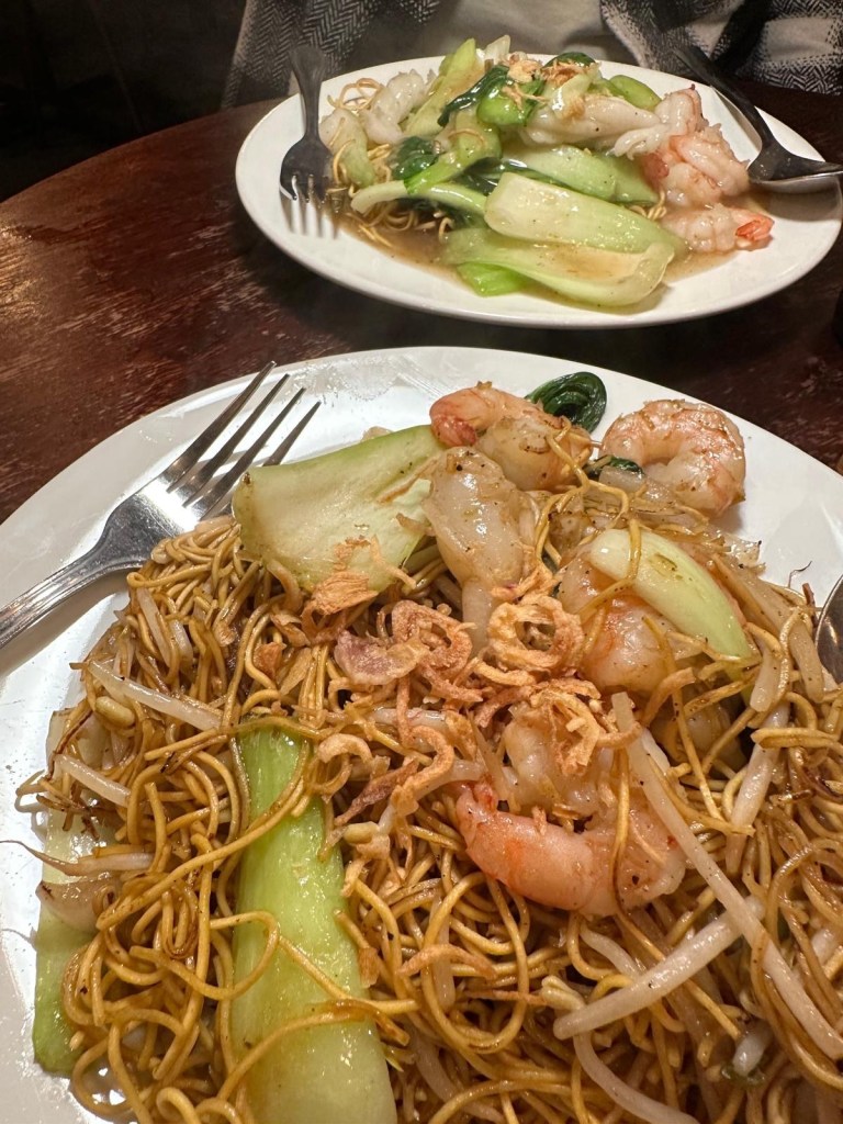 A spread of Vietnamese dishes at Ngon Café Newcastle including vermicelli noodle bowls, grilled king prawns, and sticky fish sauce wings.
