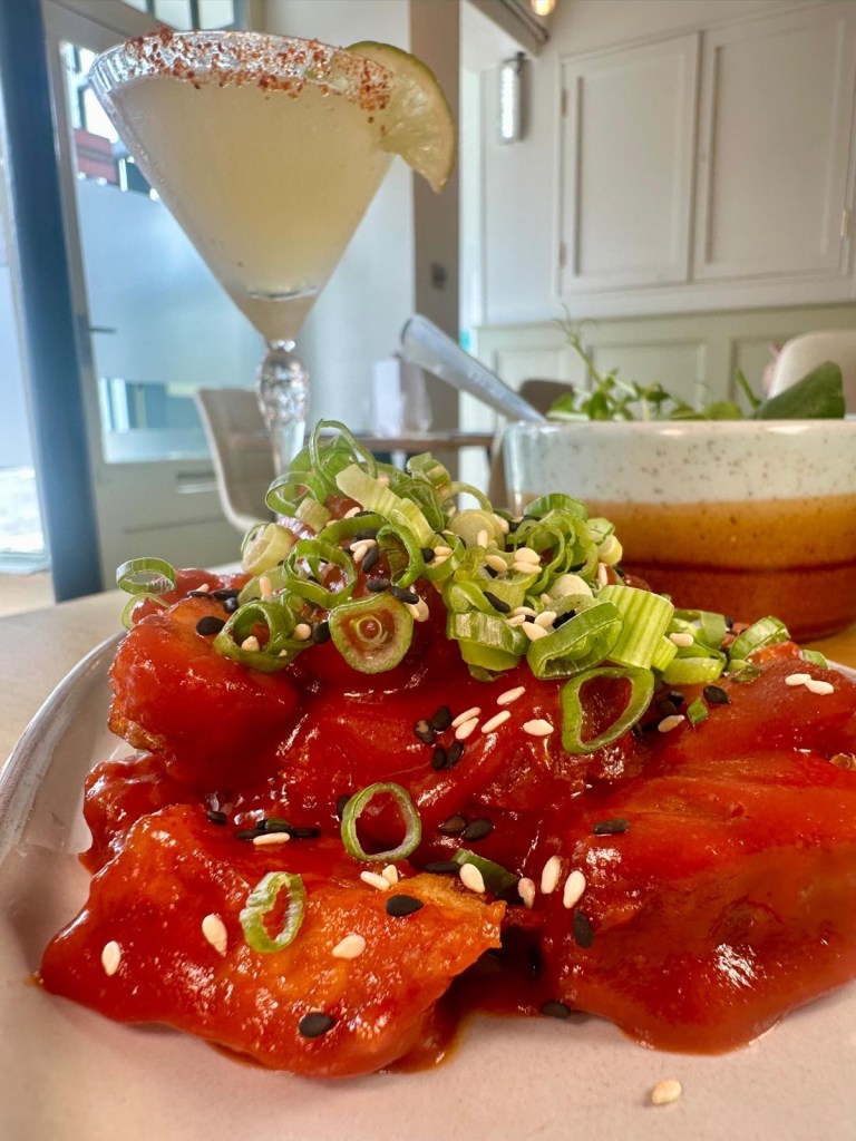Sticky Korean pork belly with sesame seeds and fresh spring onions served at Isla Durham.
