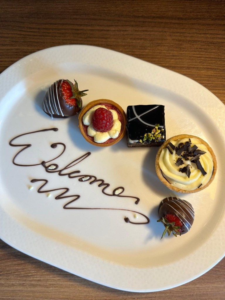 A tray of welcome cakes served in a guest room at Radisson Blu Durham, featuring mini bakes and pastries