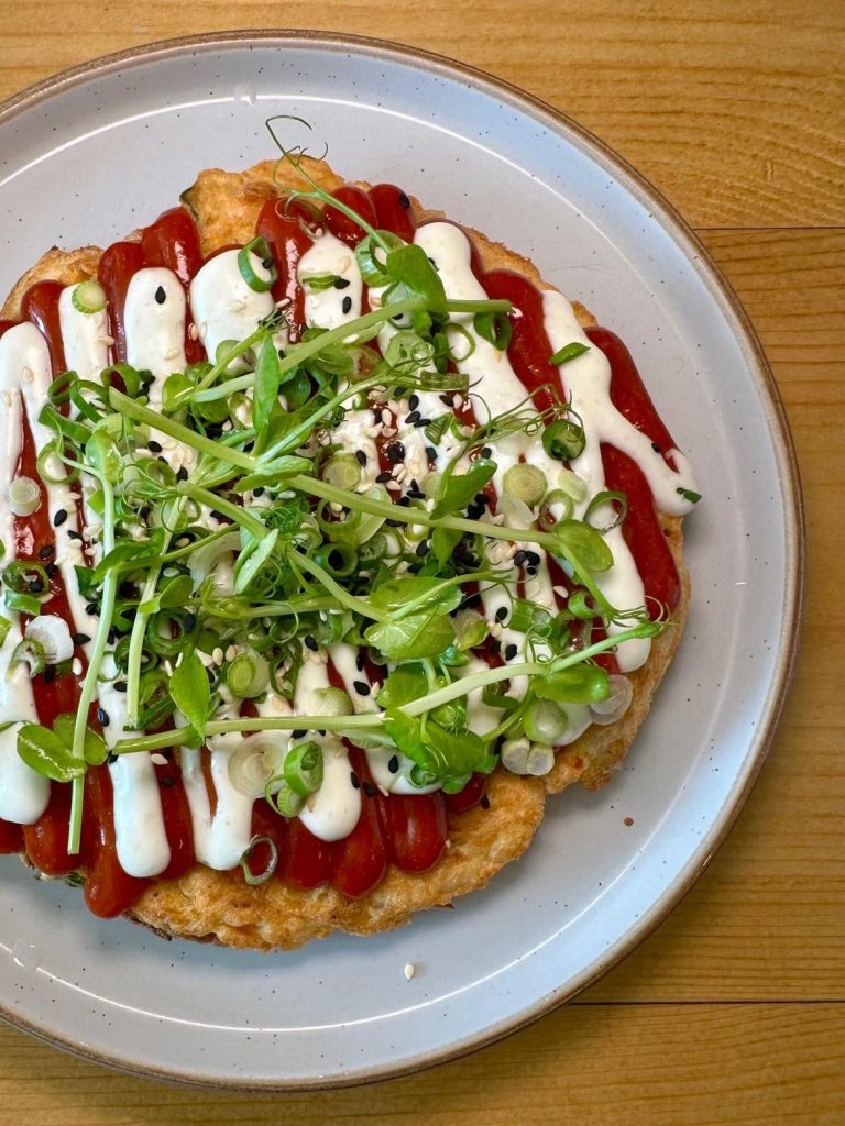 Japanese vegetable pancake topped with Korean garlic sauce and sesame seeds at Isla restaurant in Durham.