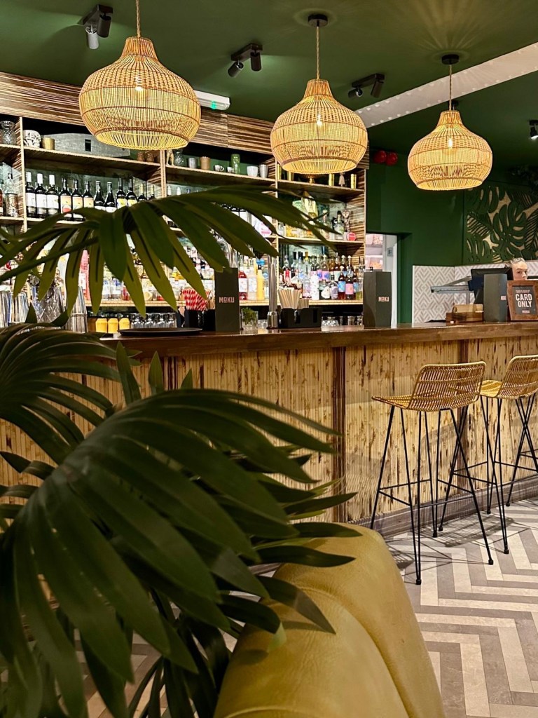Tropical-themed dining area with island decor at Moku Newcastle