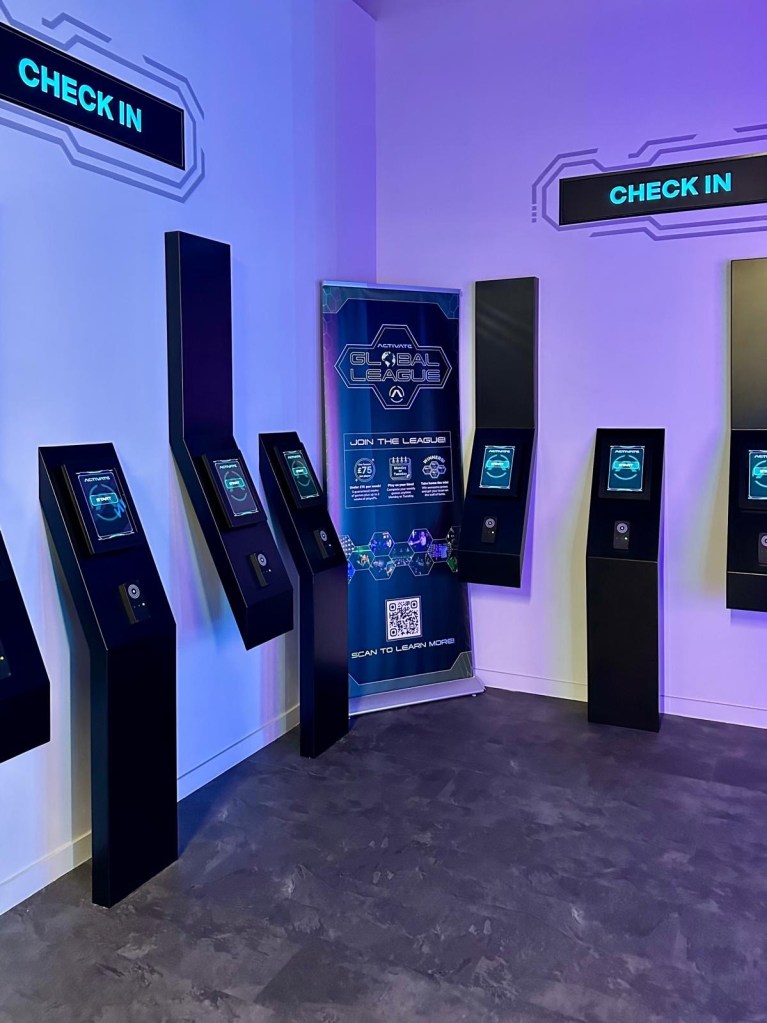 Activate Metrocentre check-in desk with neon signage and staff ready to welcome visitors in Gateshead