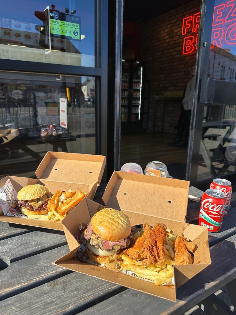 Burger meal deals in takeaway boxes from Friez&Burgz Newcastle, including the peppercorn special and the original with pastrami.