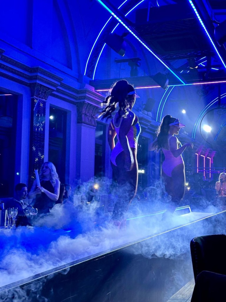 Purple Peacock Newcastle stage dancers performing on stage in vibrant costumes