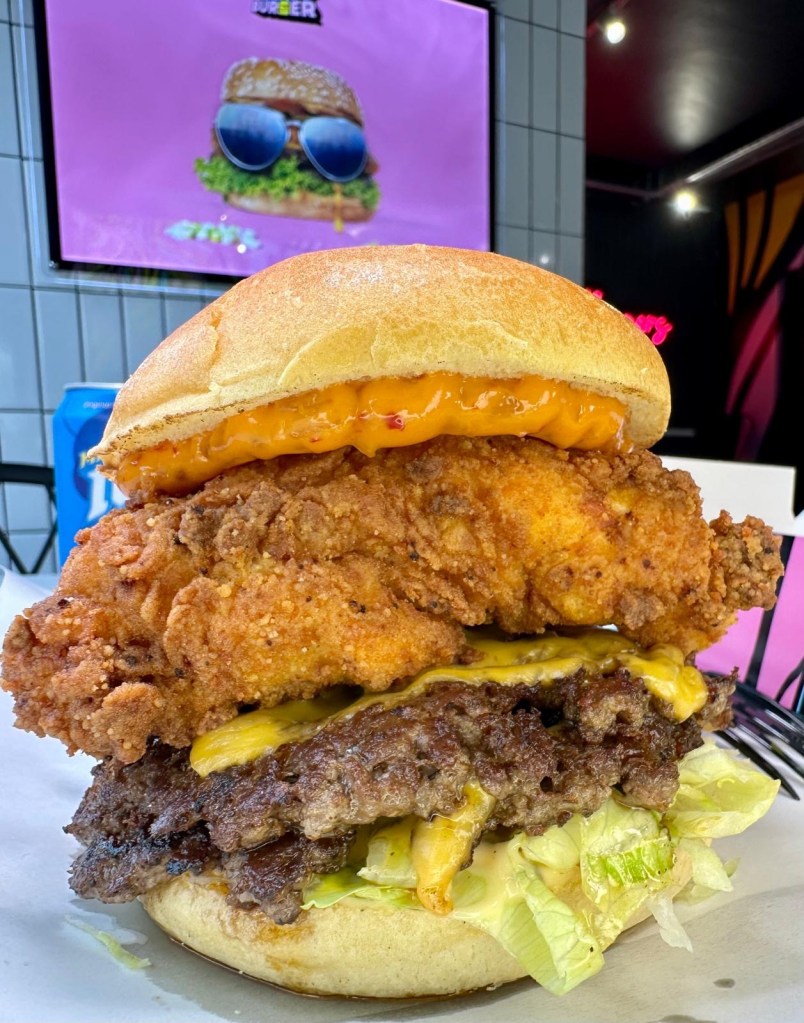 Stacked gourmet burger with fries at Burger Drop Newcastle