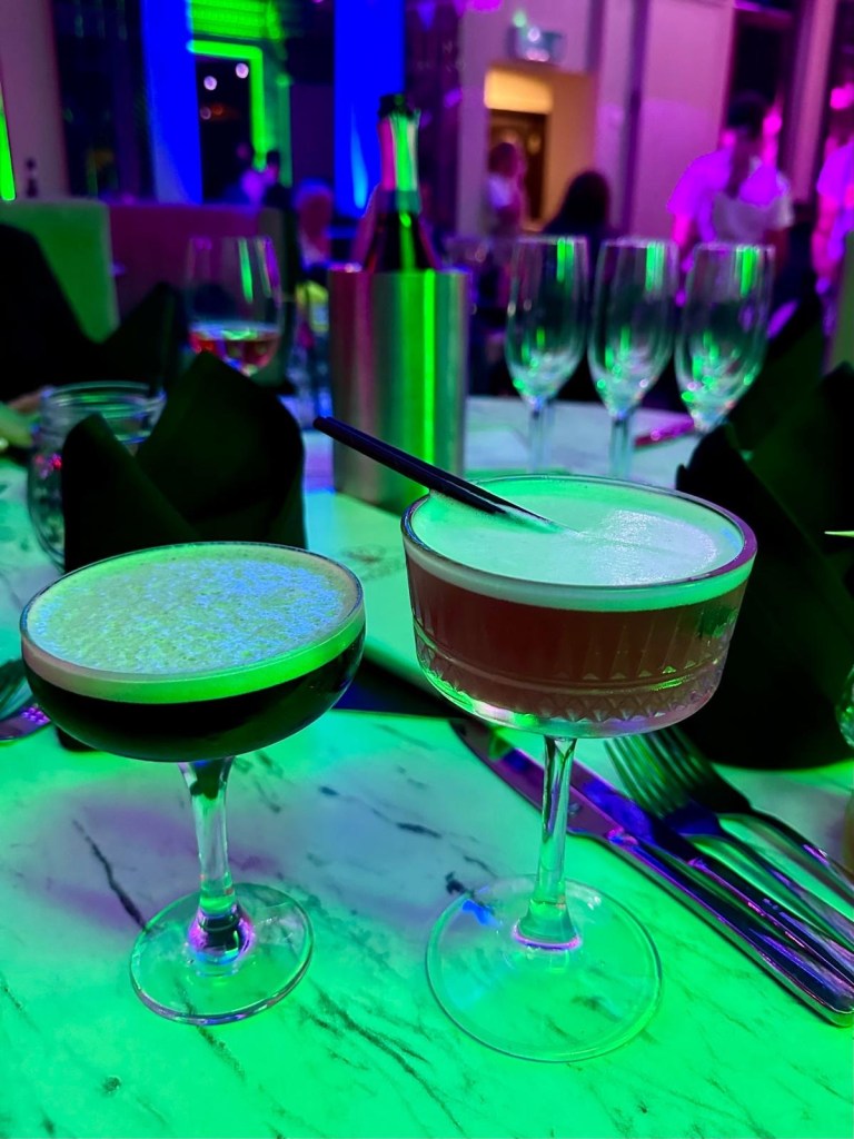 Purple Peacock Newcastle stage dancers performing on stage in vibrant costumes