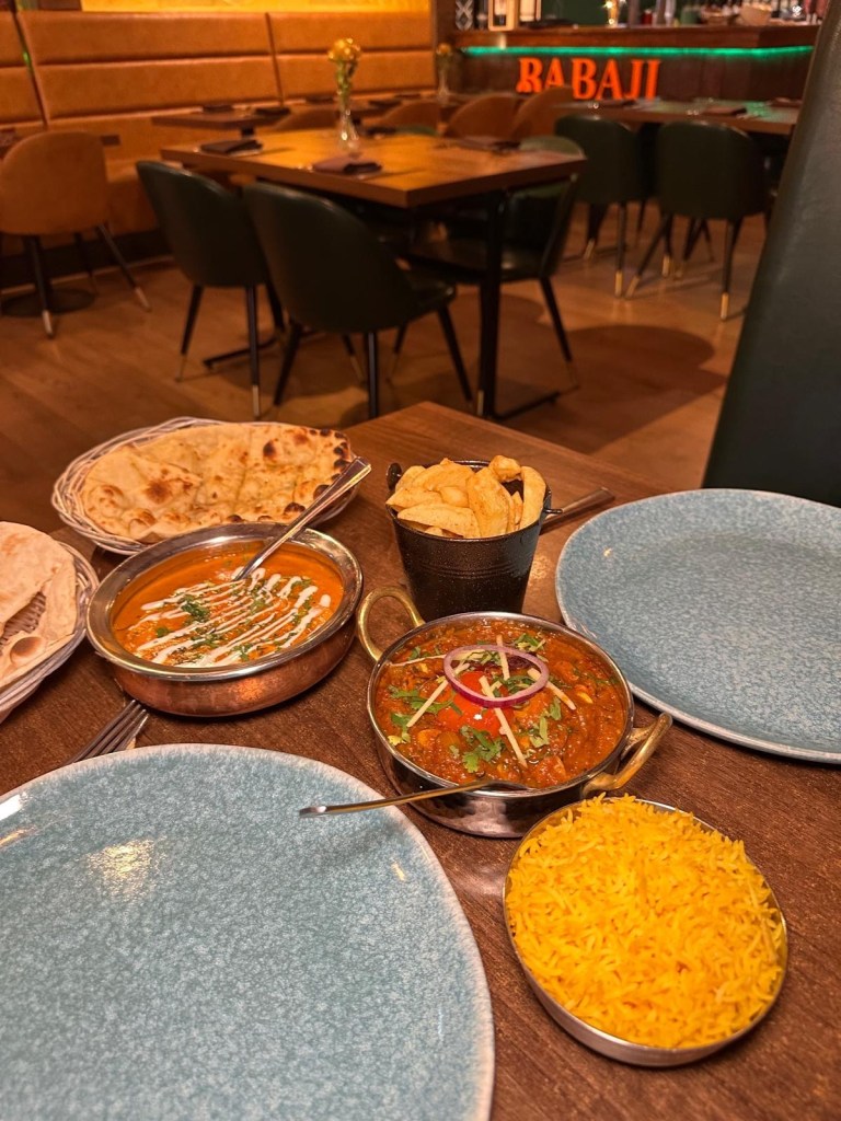 Selection of Indian dishes at Babaji Sunderland including starters, curries, bread, rice, and prawns.