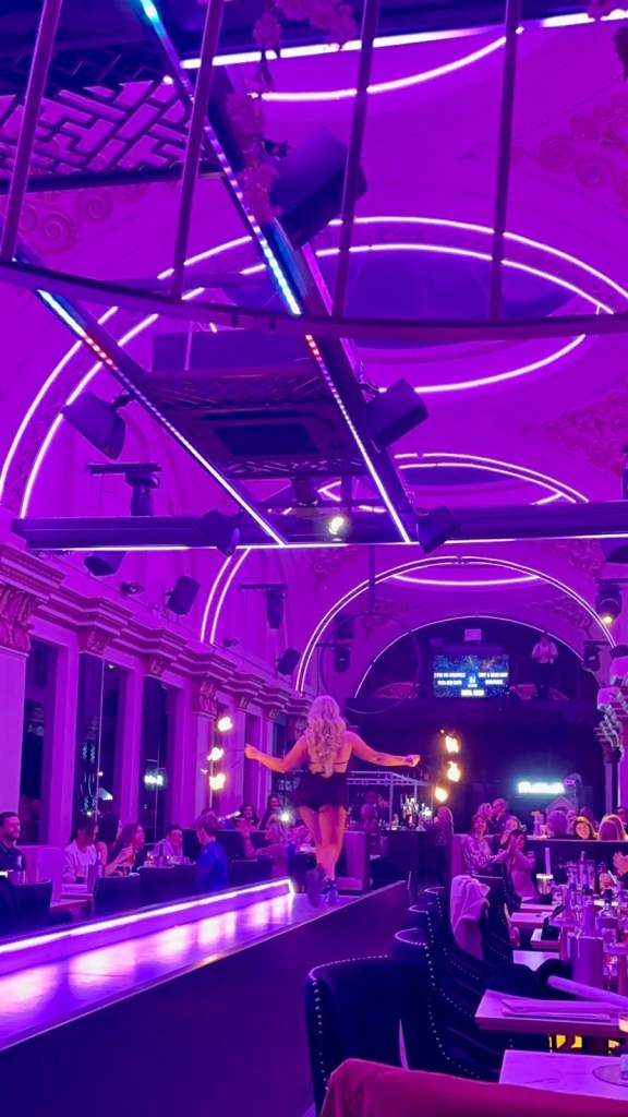 Purple Peacock Newcastle stage dancers performing on stage in vibrant costumes