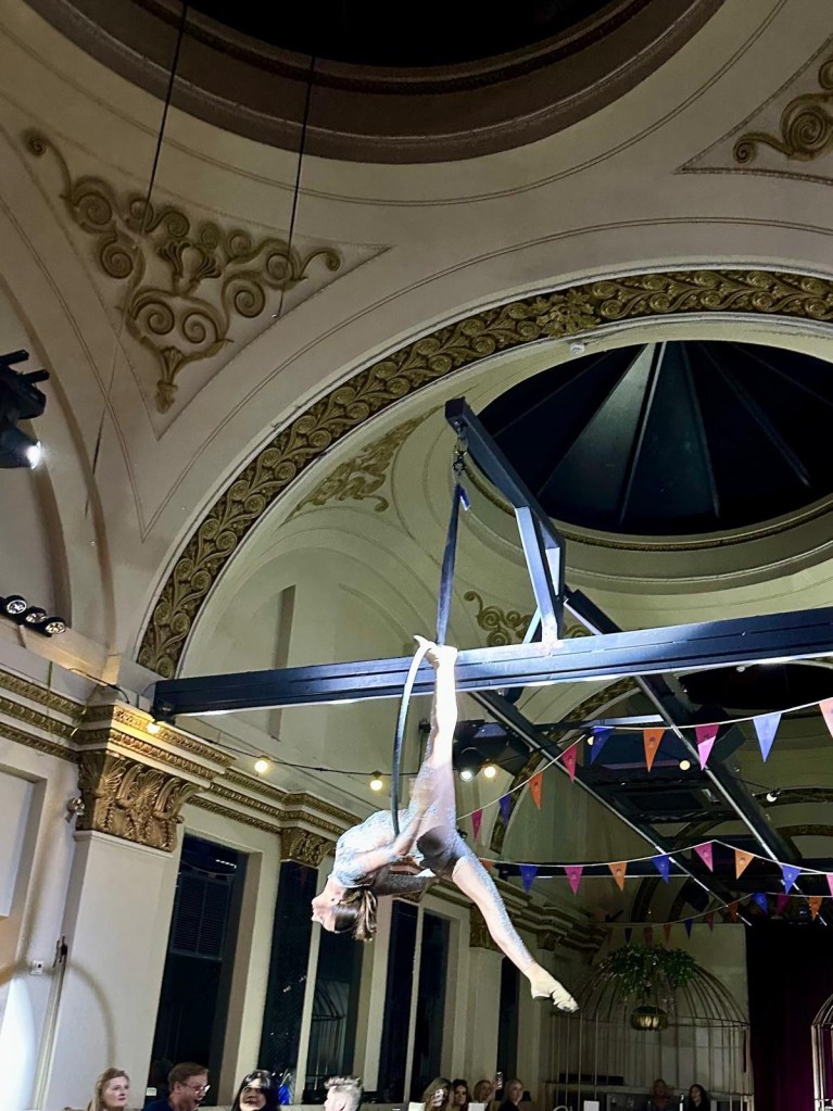 Purple Peacock Newcastle stage dancers performing on stage in vibrant costumes