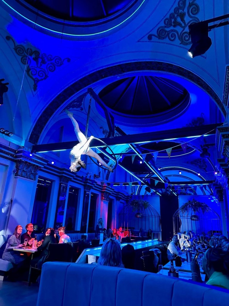 Purple Peacock Newcastle stage dancers performing on stage in vibrant costumes