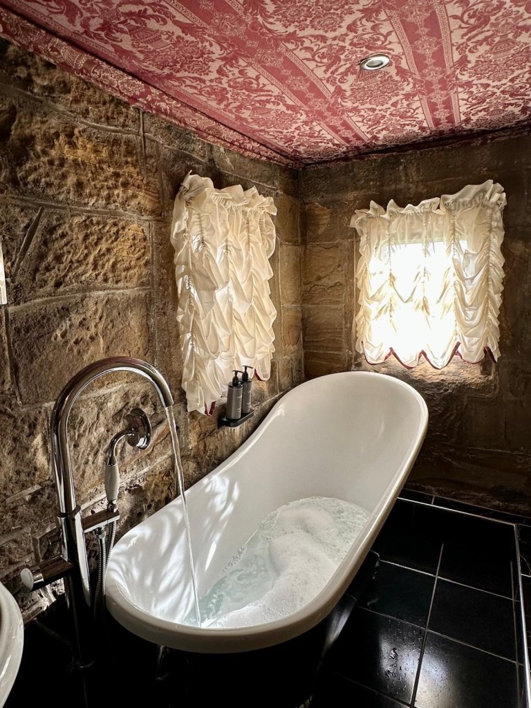 Bathroom inside the Earl of Somerset Room with elegant decor and traditional touches.