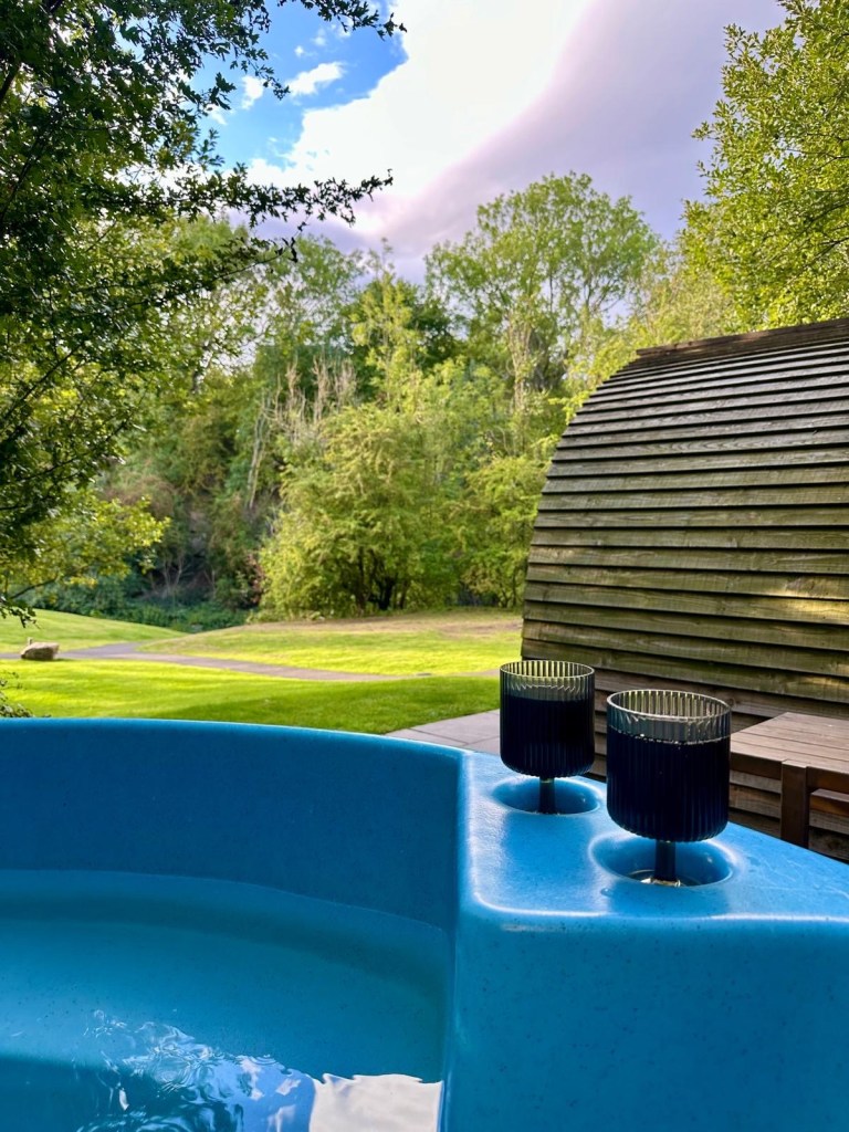 Outdoor hot tub, fire pit, and sauna at Hewn Yorkshire.