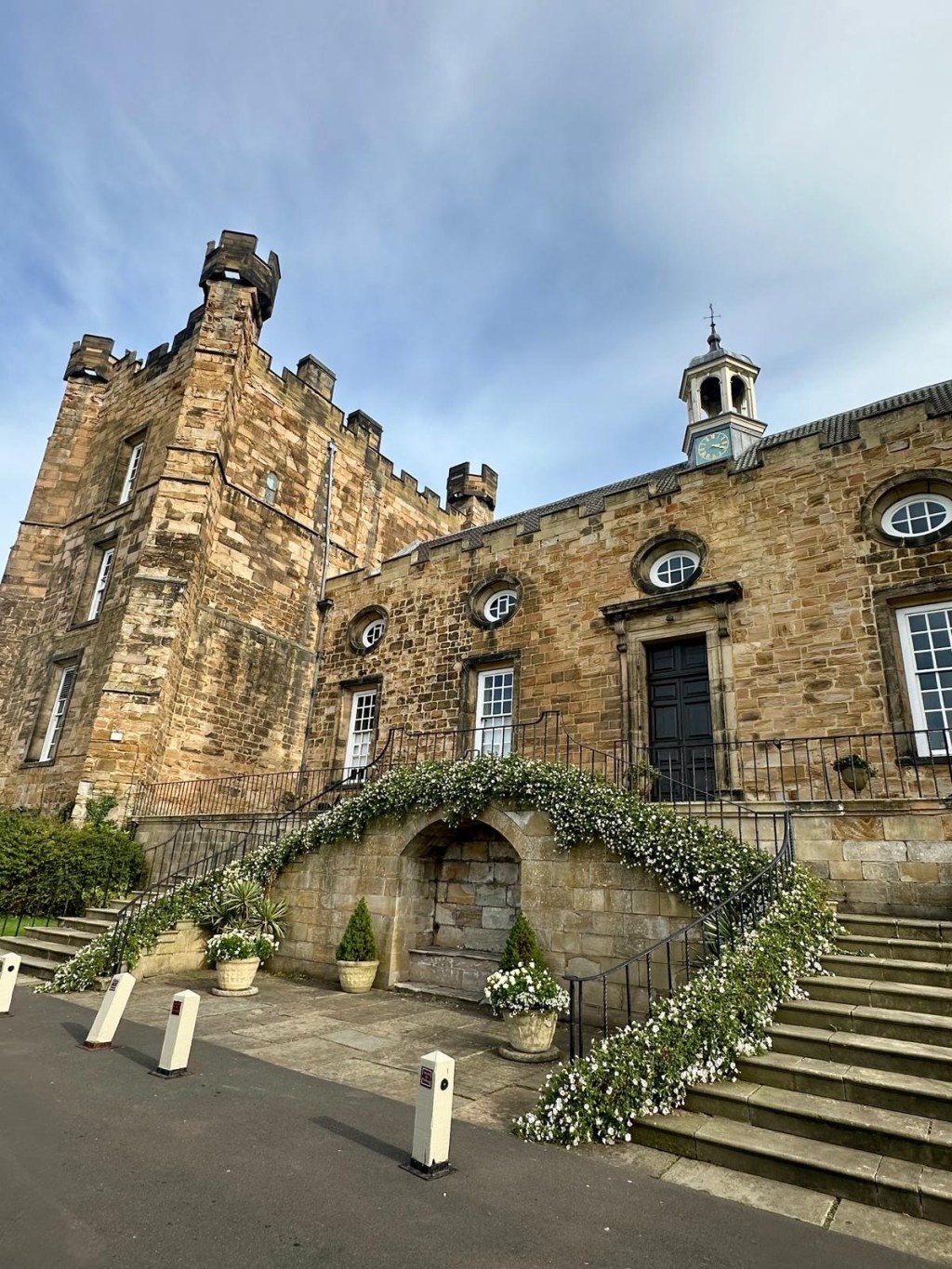 Stone entrance of Lumley Castle Hotel with turrets and medieval features.