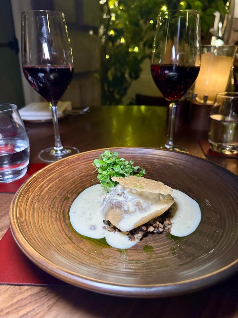 Black truffle ravioli with spinach and mushrooms served on fine china at Lumley Castle Durham.