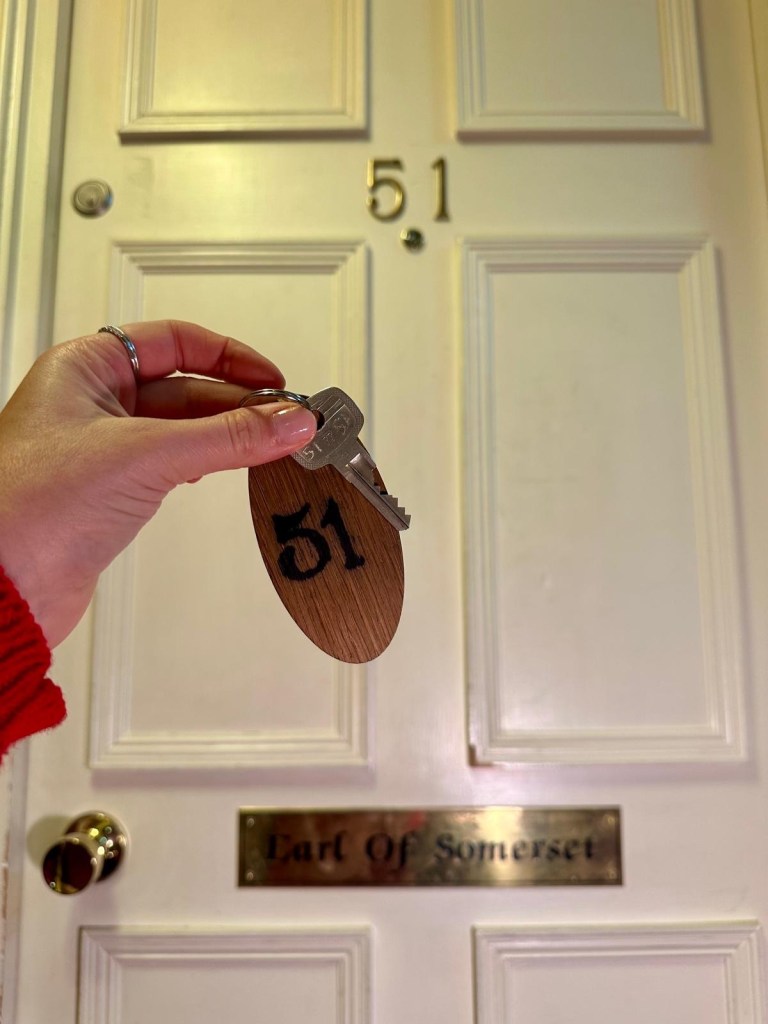 Earl of Somerset Room at Lumley Castle Hotel featuring a four-poster bed and large historic windows.