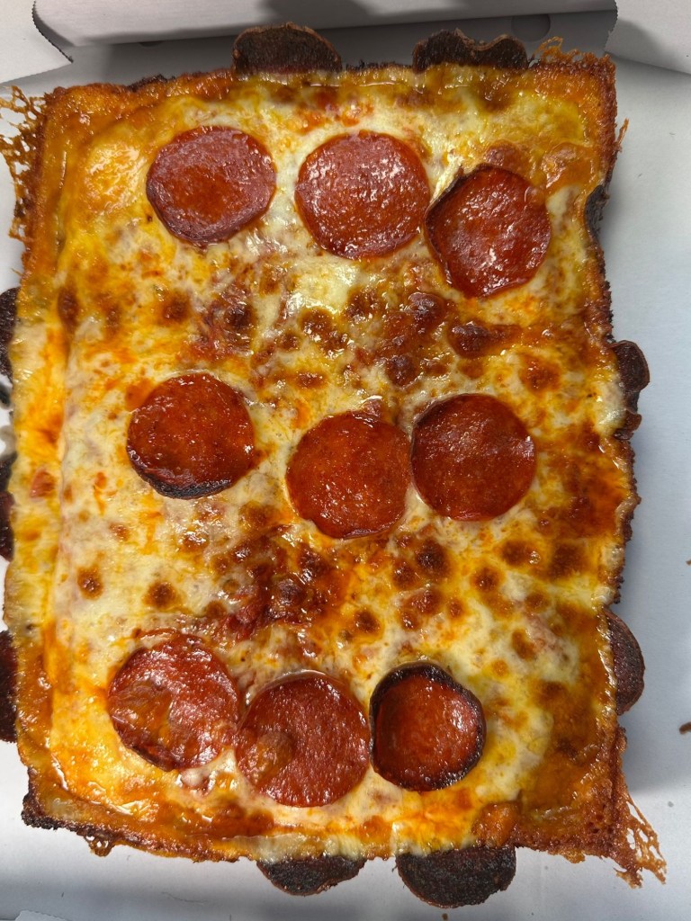 Slab Shop Double Down pizza with layers of double pepperoni and a crispy pepperoni crust.