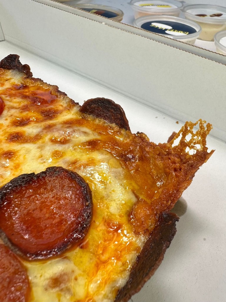 Slab Shop Double Down pizza with layers of double pepperoni and a crispy pepperoni crust.