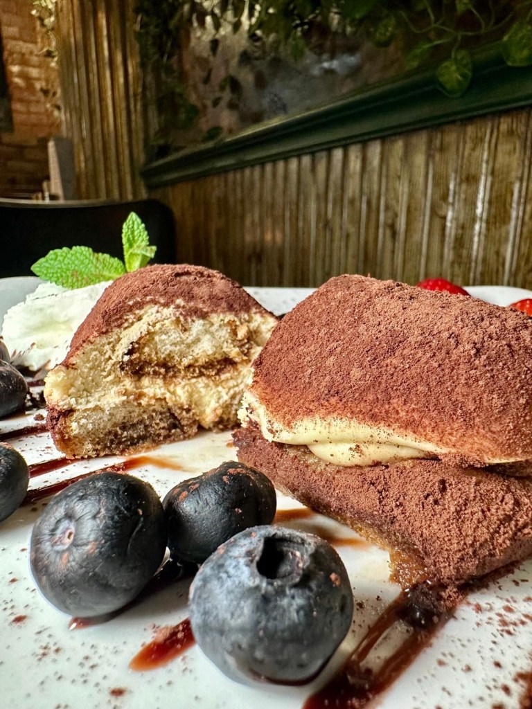 Classic Italian tiramisu dessert at Pacino’s South Shields topped with cocoa powder.