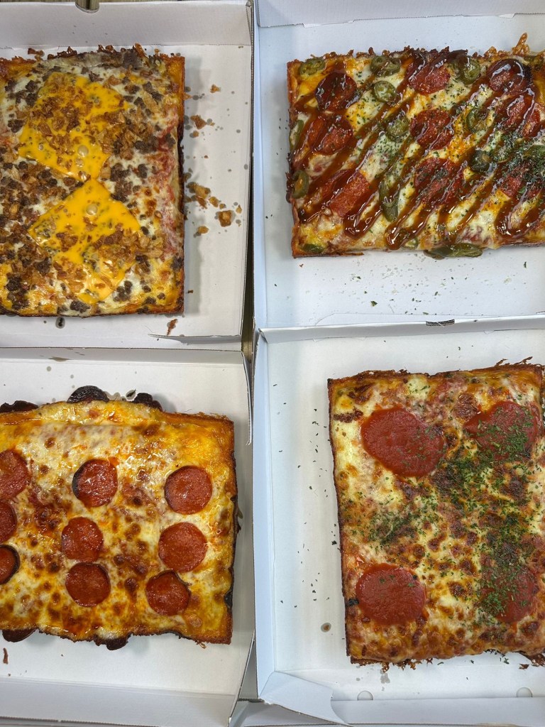 Selection of Detroit-style pizzas from Slab Shop Newcastle, featuring pepperoni, jalapeños, chilli caramel, cheese, beef and crispy onions.