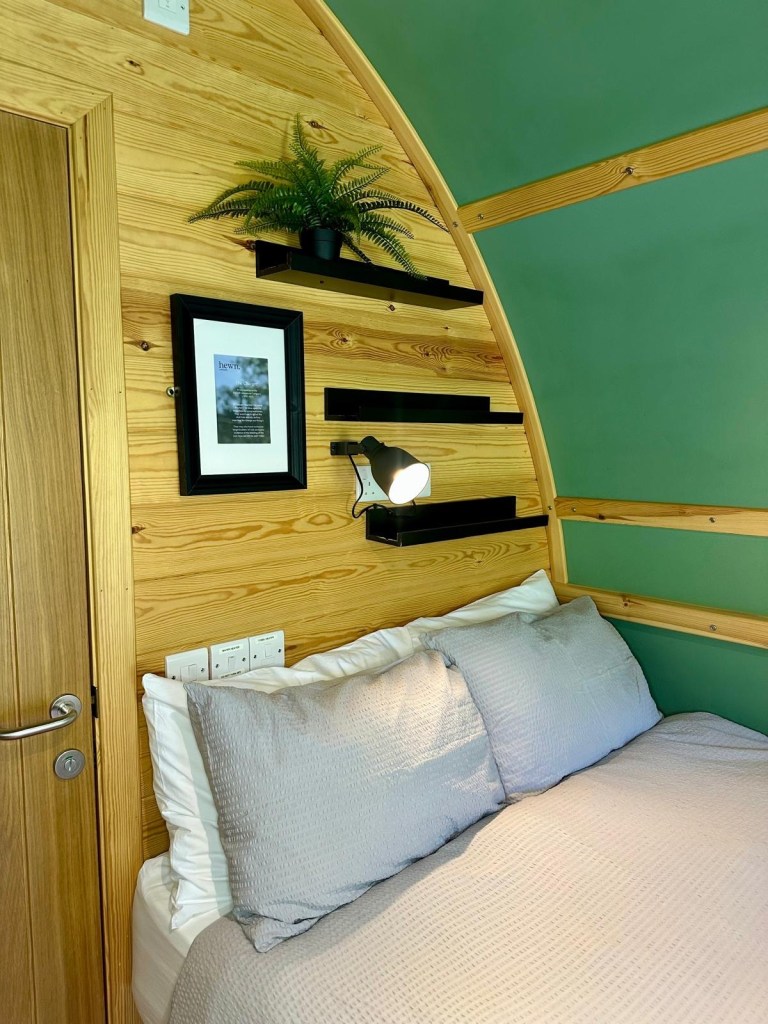 Interior of Hewn Yorkshire cabin with Scandi-style pale wood and sage decor.