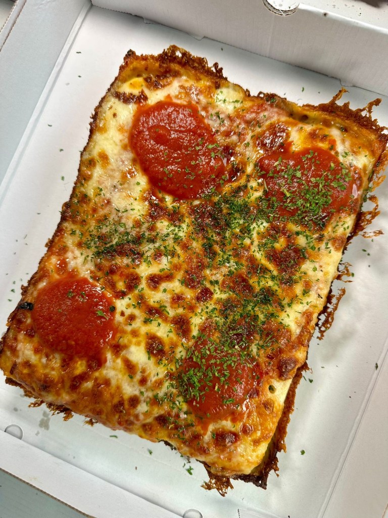 House Classic Detroit pizza slab with cheese, red sauce and fresh parsley garnish